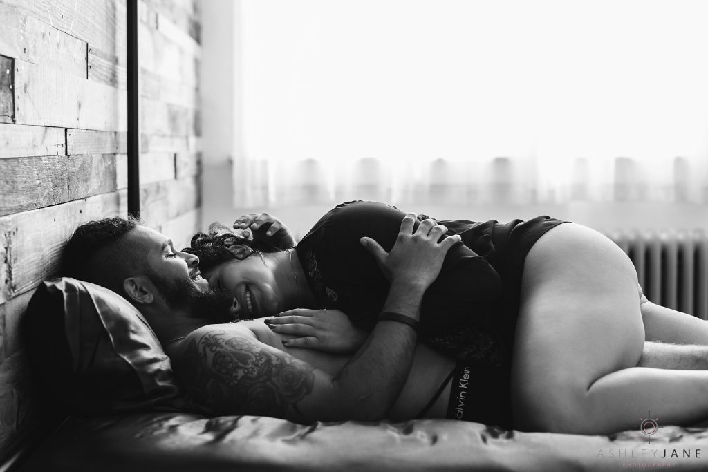 Boudoir image, laughing in bed