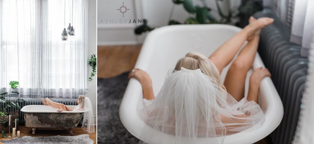 Boudoir model laying in clawfoot tub wearing her bridal veil. 