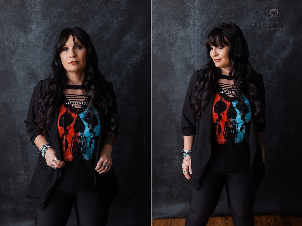 Beautiful tattooed model and photographer with long dark wearing black pants and a black jacket over a Deftones band T-shirt